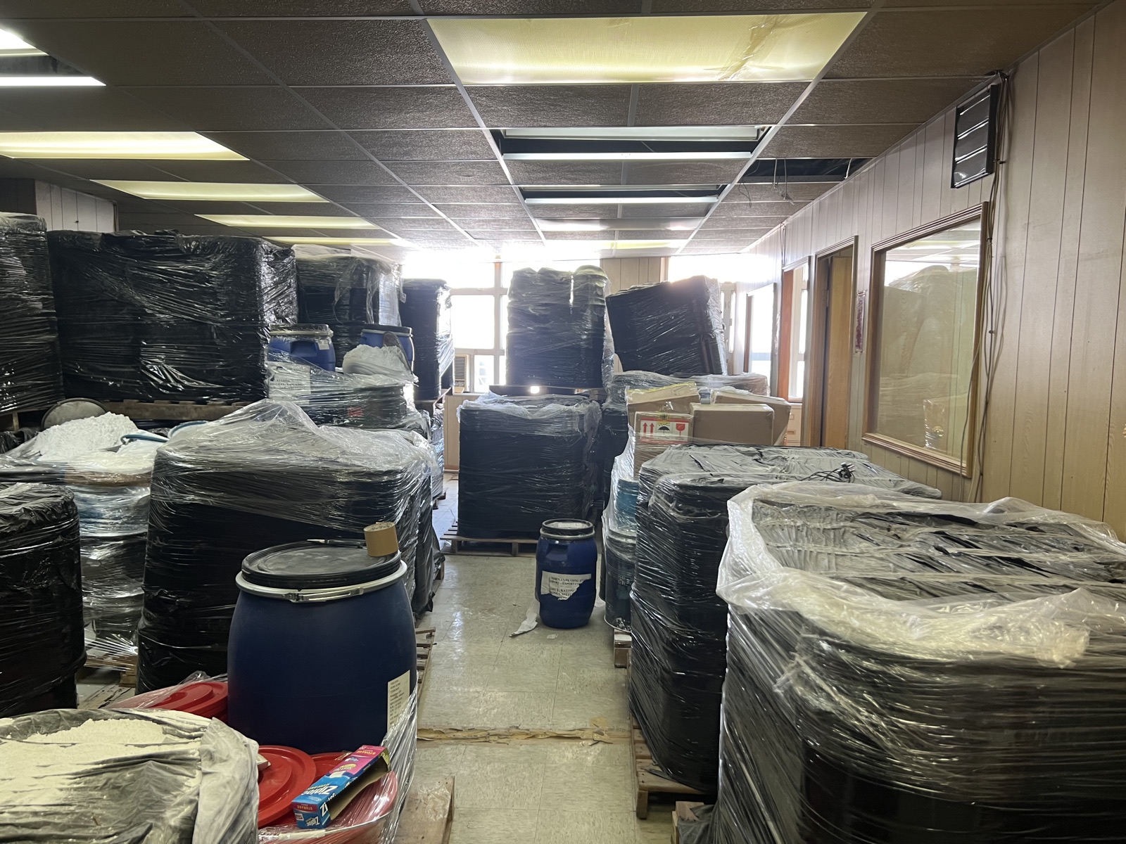 Pallets of steel drums wrapped and staged for export