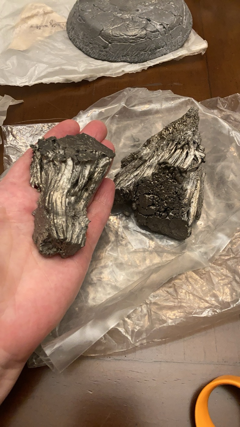 Fractured high-purity metal fragments with a visible crystalline structure